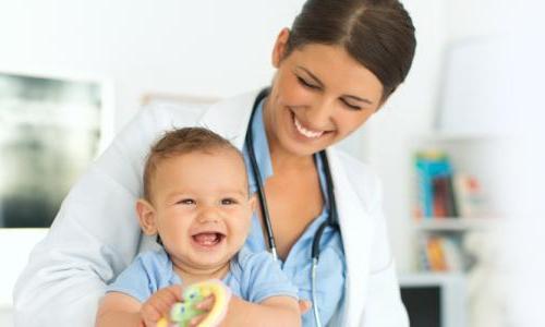 PNP Pediatric nurse practitioner smiling with baby patient